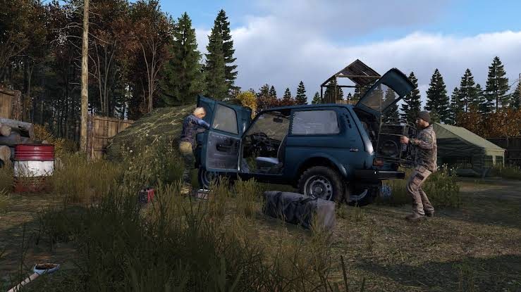 DayZ players repairing a car together